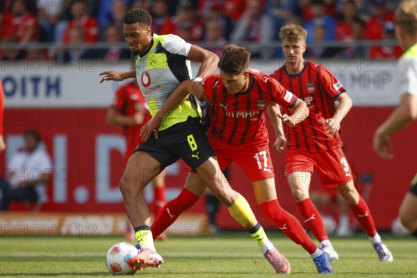 Football, Bundesliga 1, Matchday 3, 2025/2026, 1. FC Heidenheim vs. Borussia Dortmund, 13/09/2025, Voith-Arena, Heidenheim, Germany, Felix NMECHA Borussia Dortmund 8 left in duel with Mathias HONSAK 1. FC Heidenheim