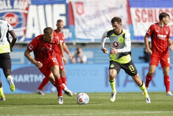 Football, Bundesliga 1, Matchday 3, 2025/2026, 1. FC Heidenheim vs. Borussia Dortmund, 13.09.2025, Voith-Arena, Heidenheim, Germany, Adrian BECK 1. FC Heidenheim 21 left in duel with Pascal GROSS Borussia Dortmund 13