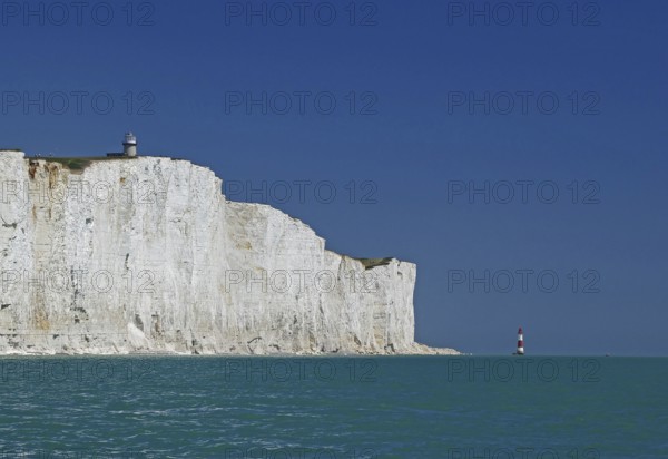 White cliffs with lighthouse under blue sky and turquoise sea, Beachy Head Lighthouse, Bournemouth, Dorset, England, Great Britain