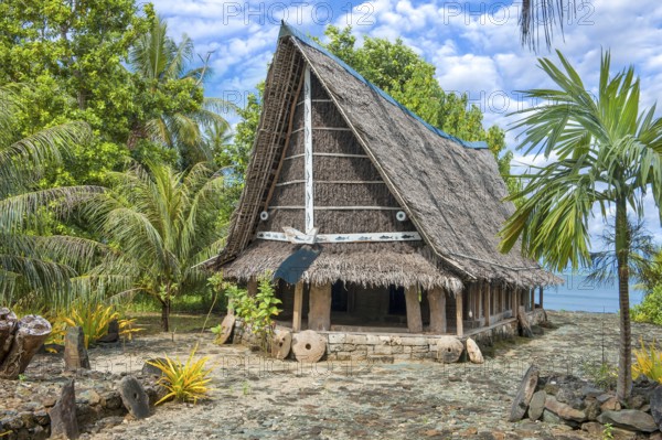 Traditional historical meeting house for men Tribal Chief Men Men's House between palm trees, in the background Pacific Ocean, Yap Island, Yap State, Caroline Islands, FSM, Federated States of Micronesia, Australia, Oceania