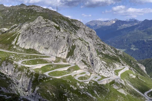 View from elevated position on serpentine hairpin bends of southern ramp southern ascent descent in southern part of old historic St. Gotthard pass road Tremola Gotthardpass Alpine pass mountain road with cobblestones, Swiss Alps, Airolo, Canton Ticino, Ticino, Switzerland