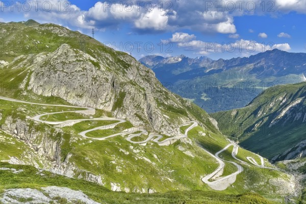 View from elevated position on serpentine hairpin bends of southern ramp southern ascent descent in southern part of old historic St. Gotthard pass road Tremola Gotthardpass Alpine pass mountain road with cobblestones, Swiss Alps, Airolo, Canton Ticino, Ticino, Switzerland