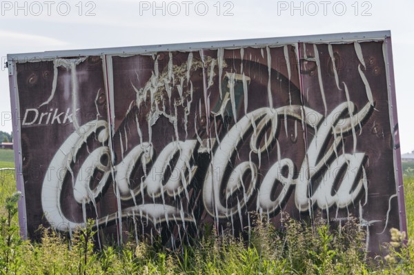 Old advertising sign Drikk Coca-Cola in a field, advertising for Coca-Cola, Jessheim, UIllensaker, Akershus county, Norway