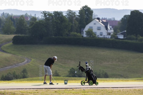 Golfer teeing off, golf course, Jessheim, UIllensaker, Akershus county, Norway