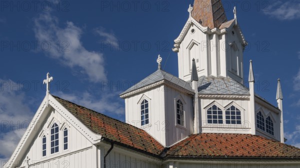 Close-up, white church building with tiled roofs, Tangen kirke or church, Olavsweg or Olavsleden, pilgrimage route, Tangen, Stange municipality, Norway