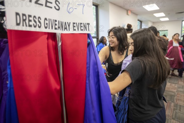Detroit, Michigan USA - 13 September 2025 - High school students search for free homecoming dresses at a formal dress giveaway sponsored by Comerica Bank and the Jackets for Jobs nonprofit. The organizations expected to give away 500 dresses during the two-day event