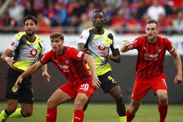 Football, 1st Bundesliga, Matchday 3, 2025/2026, 1. FC Heidenheim vs. Borussia Dortmund, 13/09/2025, Voith-Arena, Heidenheim, Germany, from left to right: Ramy BENSEBAINI Borussia Dortmund 5, Luca KERBER 1. FC Heidenheim 20, Serhou GUIRASSY Borussia Dortmund 9 and Patrick MAINKA 1. FC Heidenheim 6