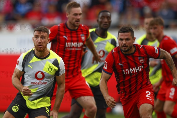 Football, Bundesliga 1, Matchday 3, 2025/2026, 1. FC Heidenheim vs. Borussia Dortmund, 13/09/2025, Voith-Arena, Heidenheim, Germany, Salih ÖZCAN Borussia Dortmund 6 left in duel with Marnon BUSCH 1. FC Heidenheim 2