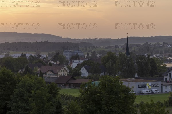 Village view with church and Schiess Ausstattungshaus, Erlen, Thurgau, Switzerland