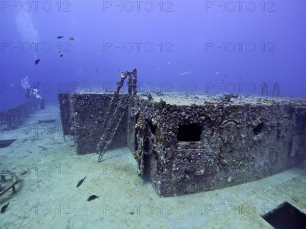 Rusty shipwreck with corals and fish in deep water. Dive site wreck of the USS Spiegel Grove, John Pennekamp Coral Reef State Park, Key Largo, Florida Keys, Florida, USA