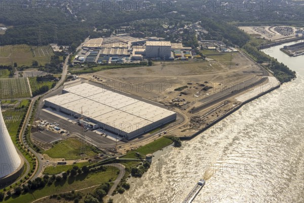 Aerial view, STEAG cogeneration plant Walsum, development and new warehouses logport VI, river Rhine, Alt-Walsum, Duisburg, Ruhr area, North Rhine-Westphalia, Germany, construction work, construction area, construction site, building plots, construction project, construction site, DE, development, Europe, industrial area, commercial area, commercial use, cogeneration plant, industrial facilities, industrial area, industrial site, capacity requirements, aerial view, aerial photography, aerial photography, new construction, overview, bird's-eye view, birds-eyes view, former Walsum colliery, logport VI, overview