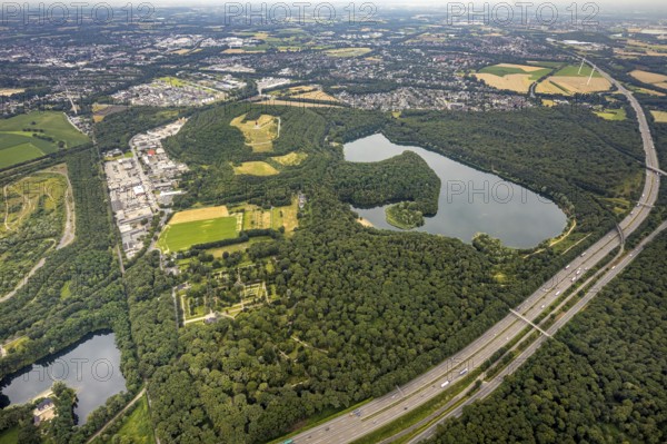 Aerial view, forest lake and slagheap Rheinpreussen, industrial area Gutenbergstraße, cemetery Lohmannsheide, Bärl, Duisburg, city limits Mörs, Ruhr area, North Rhine-Westphalia, Germany, motorway A42, burial site, slagheap, DE, Europe, cemetery, memorial, Geleucht Grubenlampe, commercial enterprises, commercial area, industrial area, commercial location, commercial use, Gottesacker, graves, burial ground, slag heap, slag heap landscape, slag heap sign, industrial area, industrial location, landmark, aerial view, aerial photography, aerial photography, Mörs, resting place, lake, symbol, overview, bird's-eye view, forest area, colliery slag heap, birds-eyes view, overview