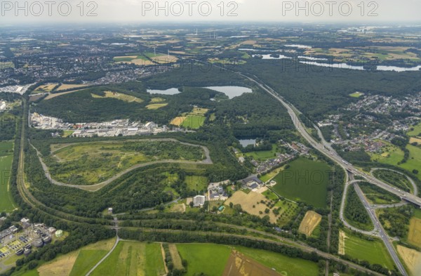 Aerial view, brownfield site Lohmannsheide spoil tip on Grafschafter Straße for planned hazardous waste landfill, Rheinpreussen spoil tip on forest lake, Gutenbergstraße industrial estate, Bärl, Duisburg, Ruhr area, North Rhine-Westphalia, Germany, spoil tip, DE, Europe, commercial enterprises, commercial area, commercial area, commercial site, commercial use, spoil tip, spoil tip landscape, spoil tip sign, industrial area, industrial site, landmark, aerial view, aerial photography, aerial photography, overview, bird's-eye view, birds-eyes view, overview