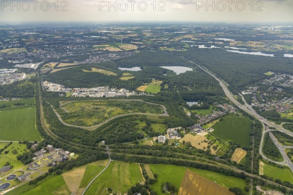 Aerial view, brownfield site Lohmannsheide spoil tip on Grafschafter Straße for planned hazardous waste landfill, Rheinpreussen spoil tip on forest lake, Gutenbergstraße industrial estate, Bärl, Duisburg, Ruhr area, North Rhine-Westphalia, Germany, spoil tip, DE, Europe, commercial enterprises, commercial area, commercial area, commercial site, commercial use, spoil tip, spoil tip landscape, spoil tip sign, industrial area, industrial site, landmark, aerial view, aerial photography, aerial photography, overview, bird's-eye view, birds-eyes view, overview