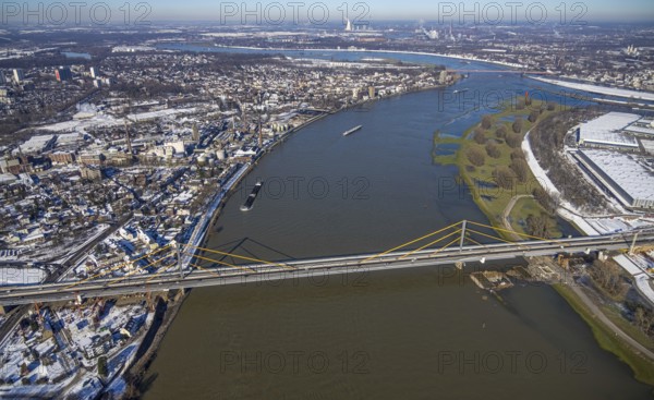 Aerial view, A40 Rhine bridge Neuenkamp, river Rhine, Homberg, Duisburg, Ruhr area, North Rhine-Westphalia, Germany, motorway, motorway bridge, bridge, DE, Duisburg road, Europe, freight transport, freight traffic, aerial photograph, aerial photography, aerial photography, shipping, shipping traffic, snow, road traffic, overview, traffic volume, bird's eye view, weighing station A40, winter, birds-eyes view, cleared road traffic, overview, flood, Rhine flood, winter flood