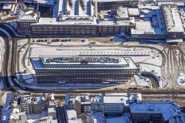 Aerial view, construction site station forecourt, MercatorOne Duisburg, Mercatorstraße, Duisburg, Ruhr area, North Rhine-Westphalia, Germany, railway station, station forecourt, DE, Deutsche Bahn AG, Europe, gastronomy, central station, main station, hotel, hotel facilities, hotel business, aerial view, aerial photography, aerial photography, snow, overview, bird's eye view, winter, birds-eyes view, cleared roads, overview