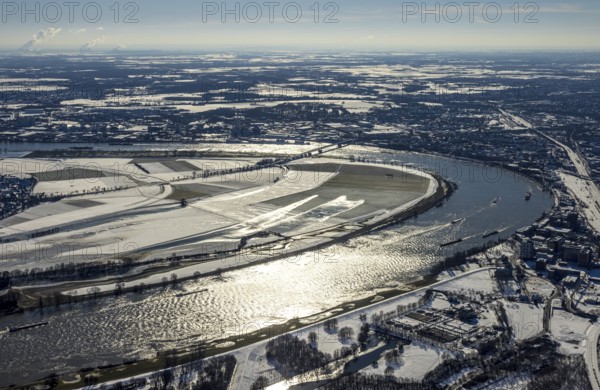 Aerial view, river Rhine, Rheinaue Ehingen with view of Mündelheim, Krefeld-Uerdingen bridge, snow-covered meadows and fields, Ürdingen, Krefeld, Ruhr area, North Rhine-Westphalia, Germany, DE, Duisburg, Europe, freight traffic, cargo ships, aerial view, aerial photography, aerial photography, shipping, snow, overview, bird's eye view, meadows and fields, winter, birds-eyes view, cleared roads, overview
