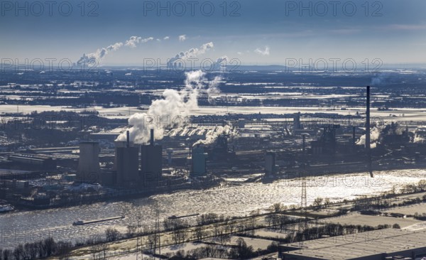 Aerial view, Hüttenwerke Krupp Mannesmann and Huckingen power station backlit, river Rhine, Friemersheim, Duisburg, Ruhr area, North Rhine-Westphalia, Germany, DE, steam, Europe, commercial enterprises, commercial area, commercial area, commercial location, commercial use, industrial area, industrial location, aerial view, aerial photography, aerial photography, smoke, snow, overview, bird's eye view, winter, birds-eyes view, cleared roads, overview