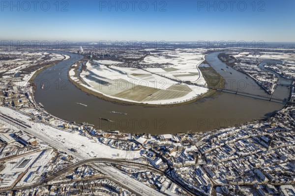 Aerial view, river Rhine, Rheinaue Ehingen with view of Mündelheim, Krefeld-Uerdingen bridge, snow-covered meadows and fields, Ürdingen, Krefeld, Ruhr area, North Rhine-Westphalia, Germany, DE, Europe, freight transport, cargo ships, aerial view, aerial photography, aerial photography, shipping, snow, overview, bird's eye view, meadows and fields, winter, birds-eyes view, cleared roads, overview