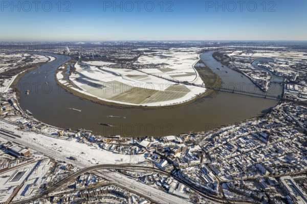 Aerial view, river Rhine, Rheinaue Ehingen with view of Mündelheim, Krefeld-Uerdingen bridge, snow-covered meadows and fields, Ürdingen, Krefeld, Ruhr area, North Rhine-Westphalia, Germany, DE, Europe, freight transport, cargo ships, aerial view, aerial photography, aerial photography, shipping, snow, overview, bird's eye view, meadows and fields, winter, birds-eyes view, cleared roads, overview