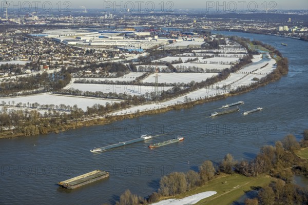 Aerial view, The Rhine with cargo ships at the Krupp Mannesmann smelting works, with a view of the Rheinaue Friemersheim, Mündelheim, Duisburg, Ruhr area, North Rhine-Westphalia, Germany, DE, Europe, aerial view, aerial photography, aerial photography, Rheinaue, snow, overview, bird's eye view, winter, birds-eyes view, cleared roads, overview