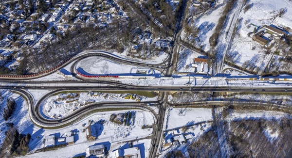 Aerial view, construction site, junction Düsseldorfer Landstraße, federal highway 288, Krefelder Straße, Duisburg, Ruhr area, North Rhine-Westphalia, Germany, construction work, construction, construction area, building site, building plots, construction measure, construction project, construction site, federal highway, federal road B288, DE, Düsseldorf, renewal, development, Europe, capacity requirements, aerial view, aerial photography, aerial photography, snow, road traffic, overview, traffic volume, bird's eye view, forest area, winter, birds-eyes view, cleared road traffic, overview