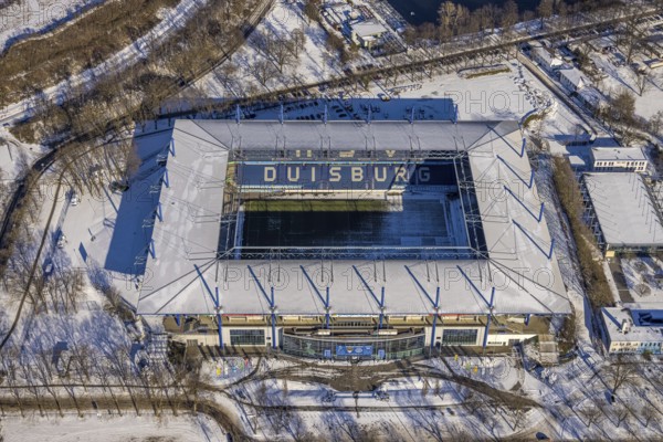 Aerial view, football stadium Schauinsland-Reisen-Arena, MSV Duisburg Arena, Sportpark Duisburg, Duisburg, Ruhr area, North Rhine-Westphalia, Germany, Arena, DE, Europe, leisure area, football pitch, football stadium, football club, aerial view, aerial photography, aerial photography, snow, sports, sports facilities, sports area, Sportpark Wedau, sports field, sports facility, stadium, overview, bird's eye view, winter, birds-eyes view, cleared roads, overview