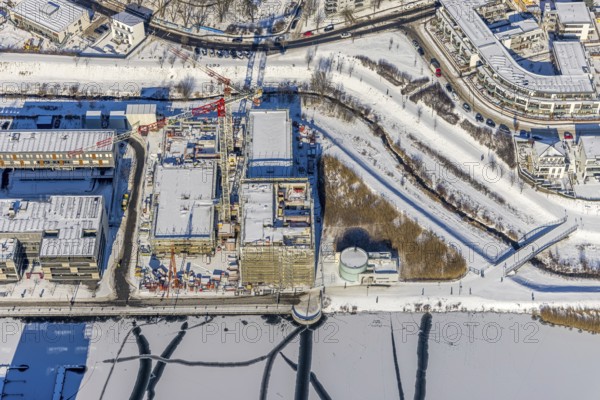 Aerial view, snow-covered Phoenix Lake, construction site of a retirement home, Hörde, Dortmund, Ruhr area, North Rhine-Westphalia, Germany, DE, Europe, aerial view, aerial photography, aerial photography, snow, lake, overview, bird's eye view, winter, winter onset, winter landscape, birds-eyes view, overview, ice, ice surface, thin ice, break in ice, breaks in ice, snow-covered ice surface, artificial lake