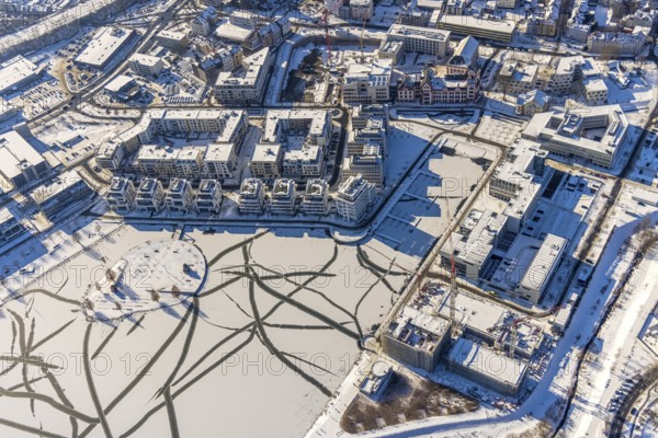 Aerial view, snow-covered Phoenix Lake, Hörder Burg, construction site of a retirement home, Hörde, Dortmund, Ruhr area, North Rhine-Westphalia, Germany, DE, Europe, commercial buildings, harbour, aerial view, aerial photography, aerial photography, snow, lake, overview, bird's eye view, winter, winter slump, winter landscape, birds-eyes view, overview, ice, ice surface, thin ice, break in the ice, breaks in the ice, snow-covered ice surface, artificial lake