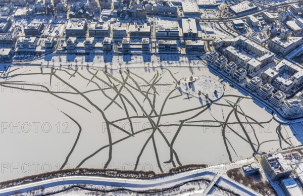 Aerial view, snow-covered Phoenix Lake, Hörde, Dortmund, Ruhr area, North Rhine-Westphalia, Germany, DE, Europe, commercial buildings, aerial view, aerial photography, aerial photography, snow, lake, overview, bird's eye view, winter, winter slump, winter landscape, birds-eyes view, overview, ice, ice surface, thin ice, break in ice, breaks in ice, snow-covered ice surface, artificial lake