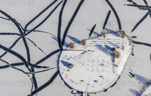 Aerial view, snow-covered Phoenix Lake, Hörde, Dortmund, Ruhr area, North Rhine-Westphalia, Germany, DE, Europe, cultural island Phoenix Lake, aerial view, aerial photography, aerial photography, snow, lake, overview, bird's eye view, winter, winter onset, winter landscape, birds-eyes view, overview, ice, ice surface, thin ice, break in the ice, breaks in the ice, snow-covered ice surface, artificial lake