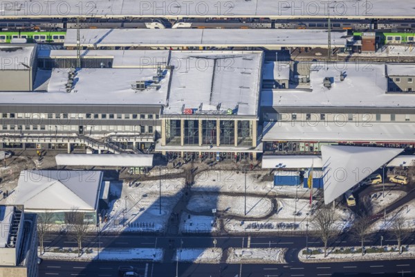 Aerial view, main station, city, Dortmund, Ruhr area, North Rhine-Westphalia, Germany, railway tracks, station, station forecourt, DE, Deutsche Bahn AG, Europe, railway tracks, main station, aerial view, aerial photography, aerial photography, snow, overview, bird's-eye view, winter, winter snowfall, winter landscape, birds-eyes view, overview, station concourse in the snow