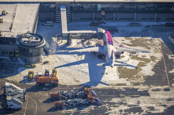 Aerial photo, Dortmund airport in winter, aeroplane, Wickede, Dortmund, Ruhr area, North Rhine-Westphalia, Germany, DE, Europe, flight mission, airport, airfield, runway, aerial photo, aerial photography, aerial photography, snow, runway, overview, bird's-eye view, winter, onset of winter, winter landscape, birds-eyes view, overview