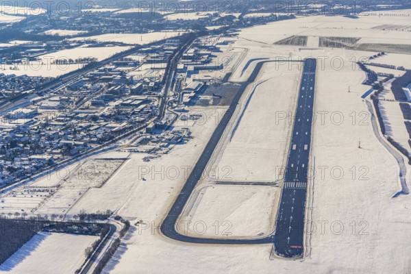 Aerial photo, Dortmund airport in winter, Wickede, Dortmund, Ruhr area, North Rhine-Westphalia, Germany, DE, Europe, flight mission, airport, airfield, runway, aerial photo, aerial photography, aerial photography, snow, runway, overview, bird's-eye view, winter, onset of winter, winter landscape, birds-eyes view, overview, cleared runway, taxiways terminal, general aviation, EDLW, General aviation, city limits Holzwickede