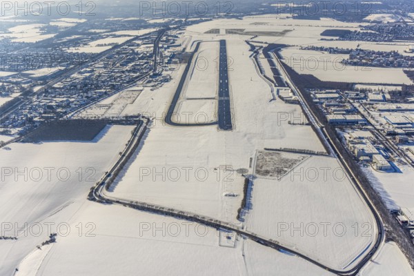 Aerial photo, Dortmund airport in winter, Wickede, Dortmund, Ruhr area, North Rhine-Westphalia, Germany, DE, Europe, flight mission, airport, airfield, runway, aerial photo, aerial photography, aerial photography, snow, runway, overview, bird's-eye view, winter, onset of winter, winter landscape, birds-eyes view, overview, cleared runway, taxiways terminal, general aviation, EDLW, General aviation, city limits Holzwickede
