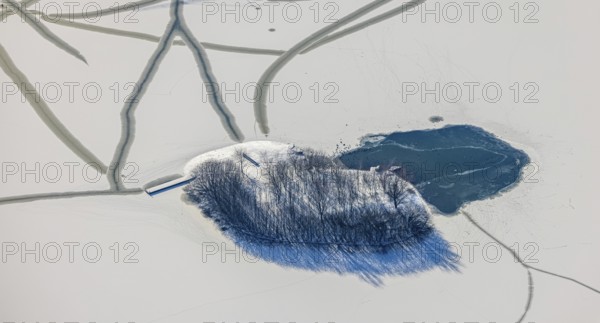 Aerial view, snow-covered island with trees in Phoenix Lake, Hörde, Dortmund, Ruhr area, North Rhine-Westphalia, Germany, trees, DE, Europe, shapes and colours, island, aerial view, aerial photography, aerial photography, snow, lake, overview, bird's eye view, winter, winter slump, winter landscape, birds-eyes view, overview, ice, ice surface, thin ice, break in ice, breaks in ice, snow-covered ice surface, artificial lake
