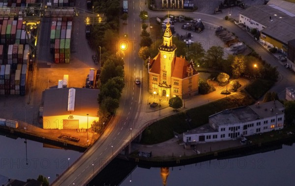 Aerial view, night view of Dortmund harbour, historic building old harbour office, coal port of the inland portDortmunder Hafen AG in Dortmund in the federal state of North Rhine-Westphalia, Germany, Dortmund, Ruhr area, North Rhine-Westphalia, DE, Europe, birds-eyes view, aerial view, aerial photography, aerial photography, overview, overview, bird's eye view, night flight, night shot, nightshot, twilight, inland port, inland port, Dortmund-Ems Canal, Speicherstraße