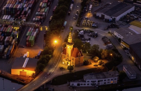 Aerial view, night view of Dortmund harbour, historic building old harbour office, coal port of the inland portDortmunder Hafen AG in Dortmund in the federal state of North Rhine-Westphalia, Germany, Dortmund, Ruhr area, North Rhine-Westphalia, DE, Europe, birds-eyes view, aerial view, aerial photography, aerial photography, overview, overview, bird's eye view, night flight, night shot, nightshot, twilight, inland port, inland port, Dortmund-Ems Canal, Speicherstraße