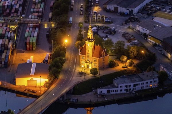 Aerial view, night view of Dortmund harbour, historic building old harbour office, coal port of the inland portDortmunder Hafen AG in Dortmund in the federal state of North Rhine-Westphalia, Germany, Dortmund, Ruhr area, North Rhine-Westphalia, DE, Europe, birds-eyes view, aerial view, aerial photography, aerial photography, overview, overview, bird's eye view, night flight, night shot, nightshot, twilight, inland port, inland port, Dortmund-Ems Canal, Speicherstraße