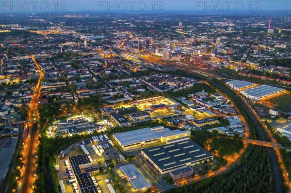 Aerial view, Hafen-Süd commercial area, Dortmund main station and city centre, Dortmund U-Tower, City, Dortmund, Ruhr area, North Rhine-Westphalia, Germany, railway station, DE, Deutsche Bahn AG, twilight photography, Europe, commercial enterprises, commercial area, commercial location, commercial use, main station, main railway station, industrial area, industrial site, culture, light pollution, aerial view, aerial photography, aerial photography, night, night photography, night flight, overview, events, event location, event venue, event centre, bird's-eye view, illuminated streets, birds-eyes view, cultural use, nightflight, overview