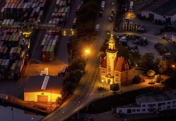 Aerial view, night view of Dortmund harbour, historic building old harbour office, coal port of the inland portDortmunder Hafen AG in Dortmund in the federal state of North Rhine-Westphalia, Germany, Dortmund, Ruhr area, North Rhine-Westphalia, DE, Europe, birds-eyes view, aerial view, aerial photography, aerial photography, overview, overview, bird's eye view, night flight, night shot, nightshot, twilight, inland port, inland port, Dortmund-Ems Canal, Speicherstraße