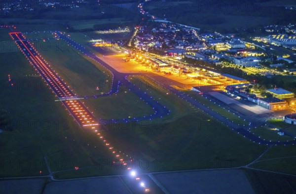 Aerial photo, Dortmund Airport, DTM, Wickede, Dortmund, Ruhr area, North Rhine-Westphalia, Germany, terminal building, DE, Dortmund Airport DTM, twilight photography, reception building, Europe, flight emission, airport, aircraft noise, airfield, runway, light pollution, aerial photograph, aerial photography, aerial photography, night, night photography, night flight, runway, overview, bird's-eye view, illuminated streets, birds-eyes view, nightflight, overview