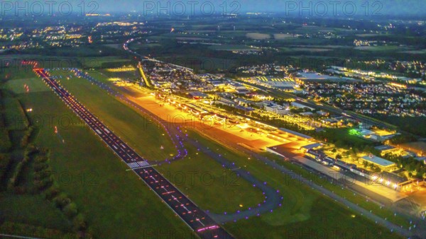 Aerial photo, Dortmund Airport, DTM, Wickede, Dortmund, Ruhr area, North Rhine-Westphalia, Germany, terminal building, DE, Dortmund Airport DTM, twilight photography, reception building, Europe, flight emission, airport, aircraft noise, airfield, runway, light pollution, aerial photograph, aerial photography, aerial photography, night, night photography, night flight, runway, overview, bird's-eye view, illuminated streets, birds-eyes view, nightflight, overview