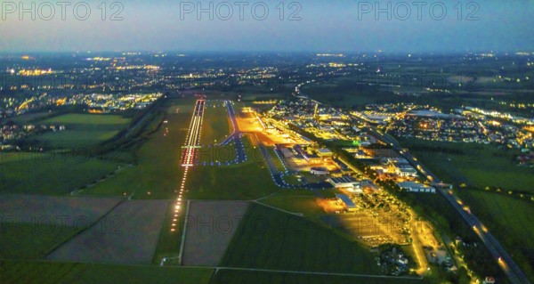 Aerial photo, Dortmund Airport, DTM, Wickede, Dortmund, Ruhr area, North Rhine-Westphalia, Germany, terminal building, DE, Dortmund Airport DTM, twilight photography, reception building, Europe, flight emission, airport, aircraft noise, airfield, runway, light pollution, aerial photograph, aerial photography, aerial photography, night, night photography, night flight, runway, overview, bird's-eye view, illuminated streets, birds-eyes view, nightflight, overview