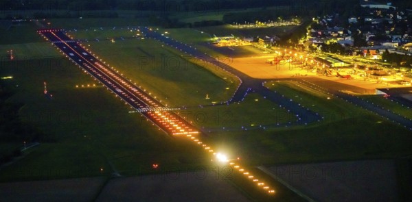 Aerial photo, Dortmund Airport, DTM, Wickede, Dortmund, Ruhr area, North Rhine-Westphalia, Germany, terminal building, DE, Dortmund Airport DTM, twilight photography, reception building, Europe, flight emission, airport, aircraft noise, airfield, runway, light pollution, aerial photograph, aerial photography, aerial photography, night, night photography, night flight, runway, overview, bird's-eye view, illuminated streets, birds-eyes view, nightflight, overview