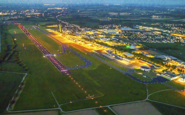 Aerial photo, Dortmund Airport, DTM, Wickede, Dortmund, Ruhr area, North Rhine-Westphalia, Germany, terminal building, DE, Dortmund Airport DTM, twilight photography, reception building, Europe, flight emission, airport, aircraft noise, airfield, runway, light pollution, aerial photograph, aerial photography, aerial photography, night, night photography, night flight, runway, overview, bird's-eye view, illuminated streets, birds-eyes view, nightflight, overview