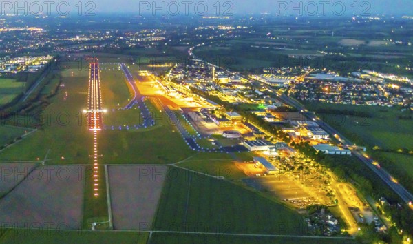 Aerial photo, Dortmund Airport, DTM, Wickede, Dortmund, Ruhr area, North Rhine-Westphalia, Germany, terminal building, DE, Dortmund Airport DTM, twilight photography, reception building, Europe, flight emission, airport, aircraft noise, airfield, runway, light pollution, aerial photograph, aerial photography, aerial photography, night, night photography, night flight, runway, overview, bird's-eye view, illuminated streets, birds-eyes view, nightflight, overview