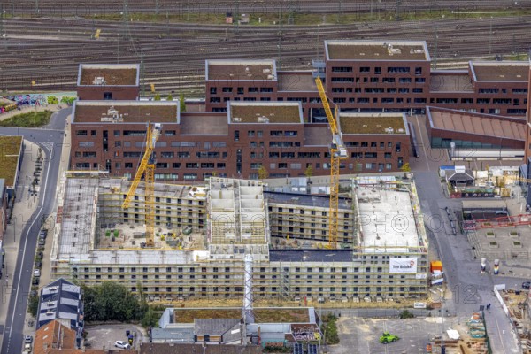 Aerial view, construction site and new construction of a residential complex at the Dortmund U-Tower with the Ostwall Museum and Leisure Centre West in the Dorstfelder Brücke district in Dortmund, Ruhr area, North Rhine-Westphalia, Germany, construction work, building, construction area, building site, building plots, construction crane, construction project, construction project, construction site, DE, Dortmund, Dortmunder U Centre for Art and Creativity, Emil-Moog-Platz, Europe, FZW, aerial view, aerial photography, aerial photography, new building, Robert-Bosch-Berufskolleg, overview, bird's-eye view, Centre for Art and Creativity, birds-eyes view, overview