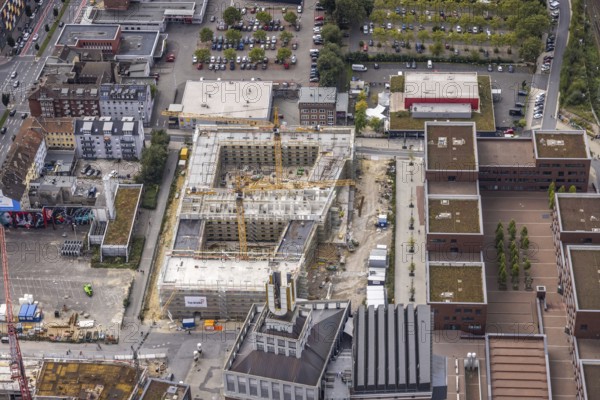 Aerial view, construction site and new construction of a residential complex at the Dortmund U-Tower with the Ostwall Museum and Leisure Centre West in the district Dorstfelder Brücke in Dortmund, Ruhr area, North Rhine-Westphalia, Germany, construction work, building, construction area, building site, building plots, building crane, construction project, construction project, construction site, DE, Dortmund, Dortmunder U Centre for Art and Creativity, Emil-Moog-Platz, Europe, FZW, aerial view, aerial photography, aerial photography, new building, Robert-Bosch-Berufskolleg, overview, bird's-eye view, Centre for Art and Creativity, birds-eyes view, overview