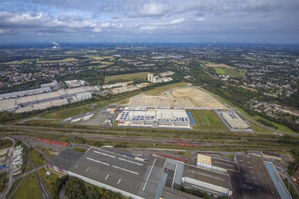Aerial view, construction site with the new REWE logistics centre on Walzwerkstraße at the old Westfalenhütte in the Borsigplatz district of Dortmund, Ruhr area, North Rhine-Westphalia, Germany, construction area, building site, building plots, construction project, construction site, brownfield site, DE, Dortmund, Europe, commercial enterprises, commercial area, commercial area, commercial location, commercial use, industrial area, industrial location, logistics, logistics service, logistics service provider, logistics provider, logistics centre, aerial view, aerial photography, aerial photography, new construction, transport service, overview, bird's-eye view, overview